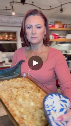 a woman holding a tray with food in it