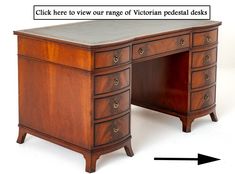 a wooden desk with an arrow pointing to the top and bottom drawer on it's left side