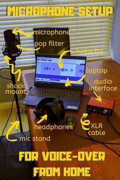 an open laptop computer sitting on top of a wooden desk next to headphones and microphones