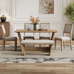 a dining table with four chairs and a bench in front of it on a rug