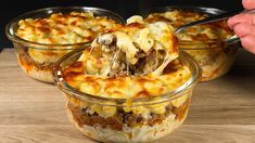 a person scooping food out of a casserole dish in three glass bowls