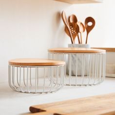 two tables with wooden utensils on top of them