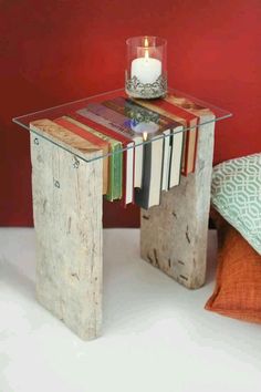 a glass table topped with books and a candle