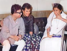 three women sitting on a couch talking to each other