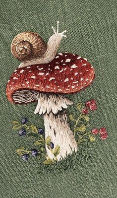 a close up of a mushroom on a piece of green fabric with flowers and leaves