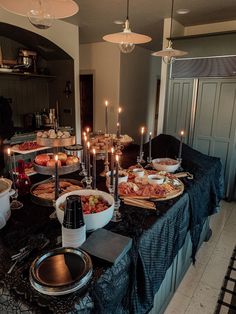 a table filled with lots of food and lit candles