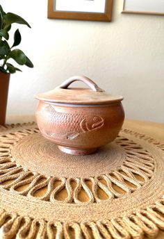 a brown pot sitting on top of a wooden table