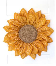 a sunflower made out of jute and burlock on a white door