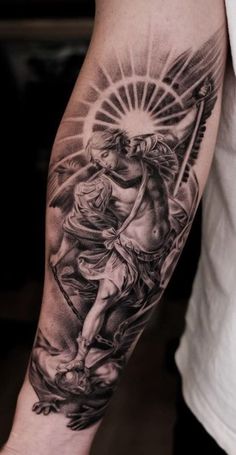 a man with a tattoo on his arm holding a cross and an angel above him