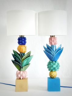 two lamps with pineapples and flowers on them