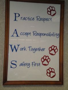 a white sign with red and blue paw prints on it that says practice respect, accept repensility, work together, safety first