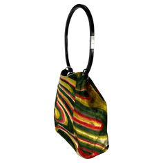 This exquisite bucket bag from Gucci's Fall/Winter 1999 collection, designed by Tom Ford, showcases his iconic psychedelic silk velvet pattern. The bag features a sleek lucite hoop handle, attached by silver metal rings that harmonize beautifully with the deep greens and reds of the velvet. A silver-plated brand plate adds a polished touch to the handle. The same pattern appears on other runway pieces, and a grey velvet version of this bag was featured in the ad campaign with model Liisa Winkler Gucci Museum, Gucci By Tom Ford, Velvet Pattern, Hermes Kelly Bag, Acrylic Ring, Mario Testino, Shopping Photography, Cartier Love, Auction Items