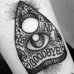 a black and white tattoo on the leg of a person's arm that reads goodbye