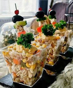 three clear containers filled with food sitting on top of a table next to each other