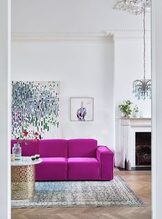 a living room filled with furniture and a chandelier