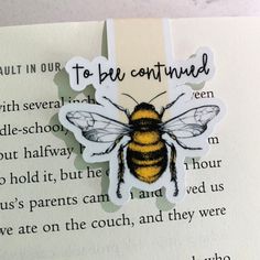 a close up of a piece of paper with a bee on it's back