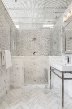 a bathroom with marble walls and flooring