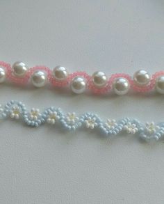 three pieces of beaded fabric with flowers and pearls on them, all in pastel colors