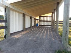 an empty covered area in the middle of a field