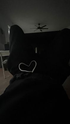 a black pillow with a white heart on it