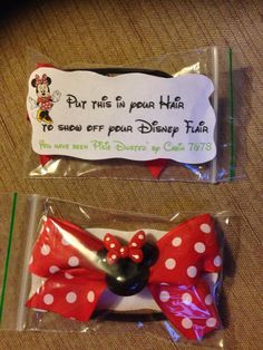 there are two plastic bags with minnie mouse hair clips in them, one has a name tag on it and the other has a polka dot bow