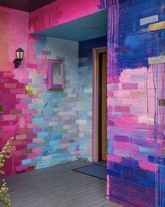 a pink and blue painted wall next to a door