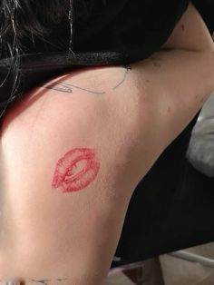 a woman with red lipstick on her back