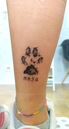 a paw print with the word mava on it's left side ankle tattoo