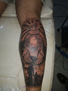 a man's leg with a tattoo on it that has an image of two hands holding