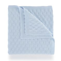 a blue blanket folded on top of a white bed sheet with a checkered design