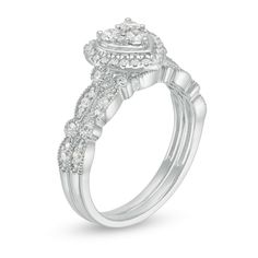 a white gold engagement ring with diamonds on the sides and an oval center stone in the middle