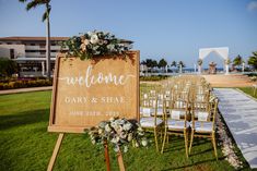 an outdoor ceremony setup with chairs and welcome sign