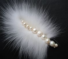 a white feather with pearls on it