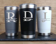 three personalized tumblers sitting on top of a counter