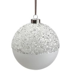 a white christmas ornament with silver glitter on it's side and a metal ball hanging from the top