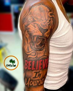 a man with a tattoo on his arm that says believe in yourself and an image of a lion