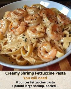 a bowl filled with pasta and shrimp on top of a wooden table next to a sign that says creamy shrimp fettuccine pasta you will need 8 ounces fettucine pasta 1 pound