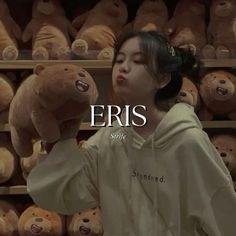 a woman standing in front of a rack of teddy bears with the words eris on it