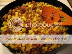 a skillet filled with food sitting on top of a stove