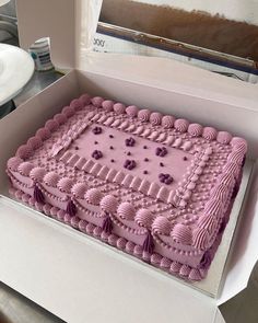 a pink cake in a box on a table