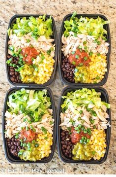 four plastic trays filled with different types of food