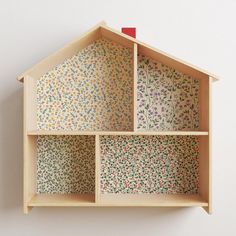 a doll house made out of plywood with flowers on it