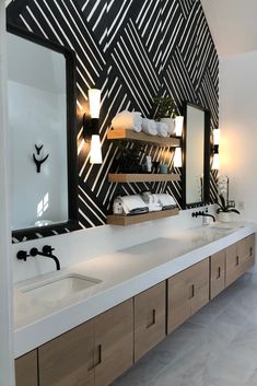 a bathroom with two sinks and a large mirror on the wall next to each other