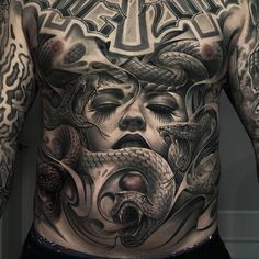 a man with tattoos on his back and chest