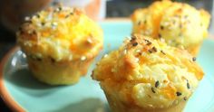 three muffins on a blue plate with sprinkles and seasoning