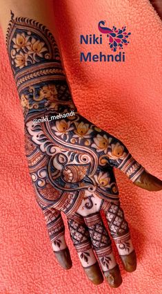 the hand is decorated with henna and flowers