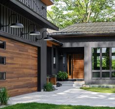 a modern house with wooden doors and windows