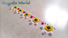 a row of decorated balls sitting on top of a white counter next to a window