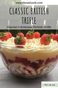 a glass bowl with strawberries on top and the words classic british trifle