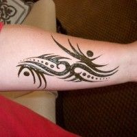 a woman's arm with a tattoo design on the side of her left arm